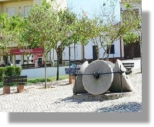 antique granite grinding stones in centre of village square